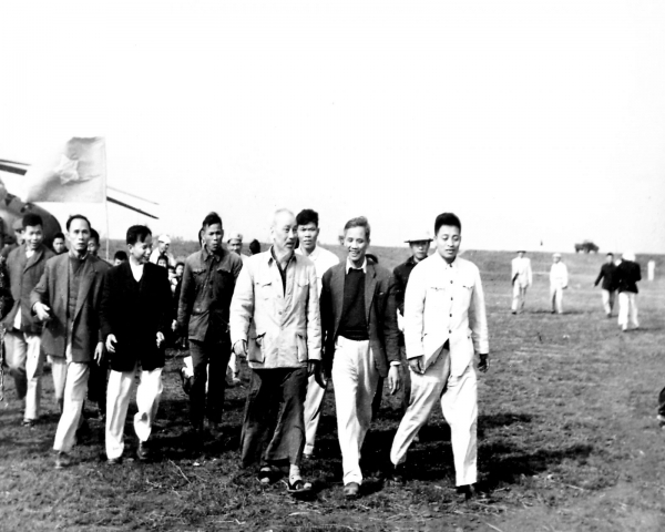 A group of men walking on a fieldDescription automatically generated