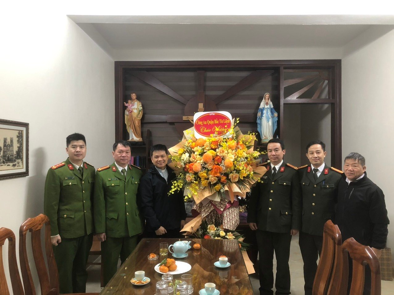 Description: A group of men in military uniforms standing in front of a tableDescription automatically generated